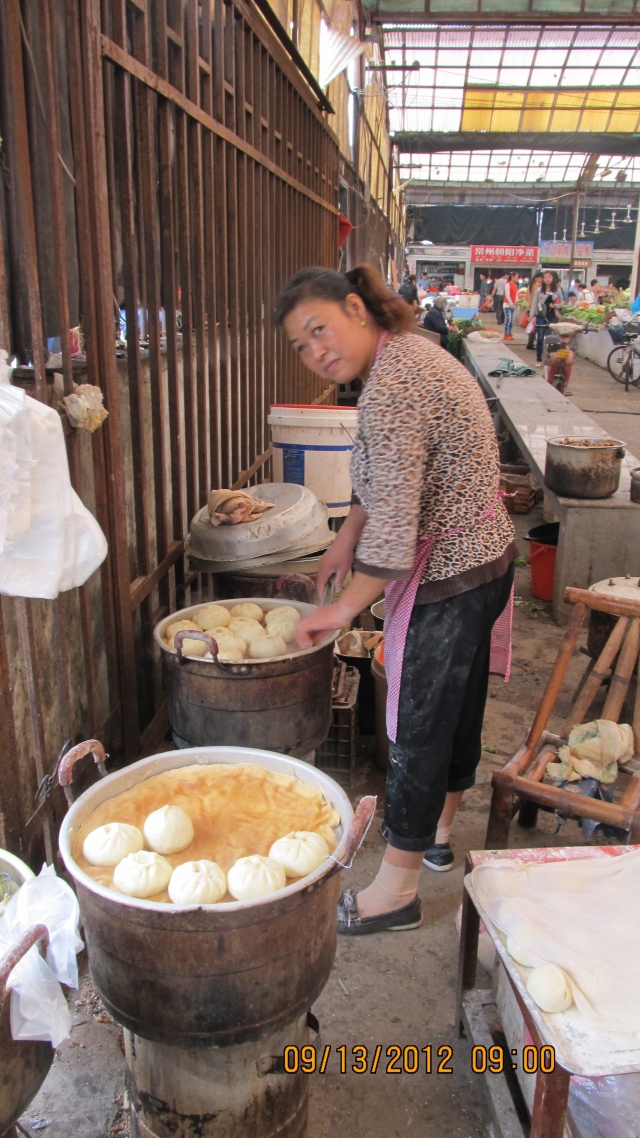 I purchase filled steamed bread (a little like a puffy dumpling) from this woman at least once a week.  She also makes sesame sticky rolls with beet paste inside that are heavenly.  The cost?  48 cents for four pieces.