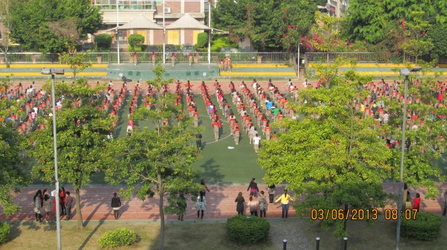 The daily opening ceremony.  Music is heard loud and clear all over the school.  First there is marching music, then exercise music, then the National Anthem of China is played as the flag is raised.